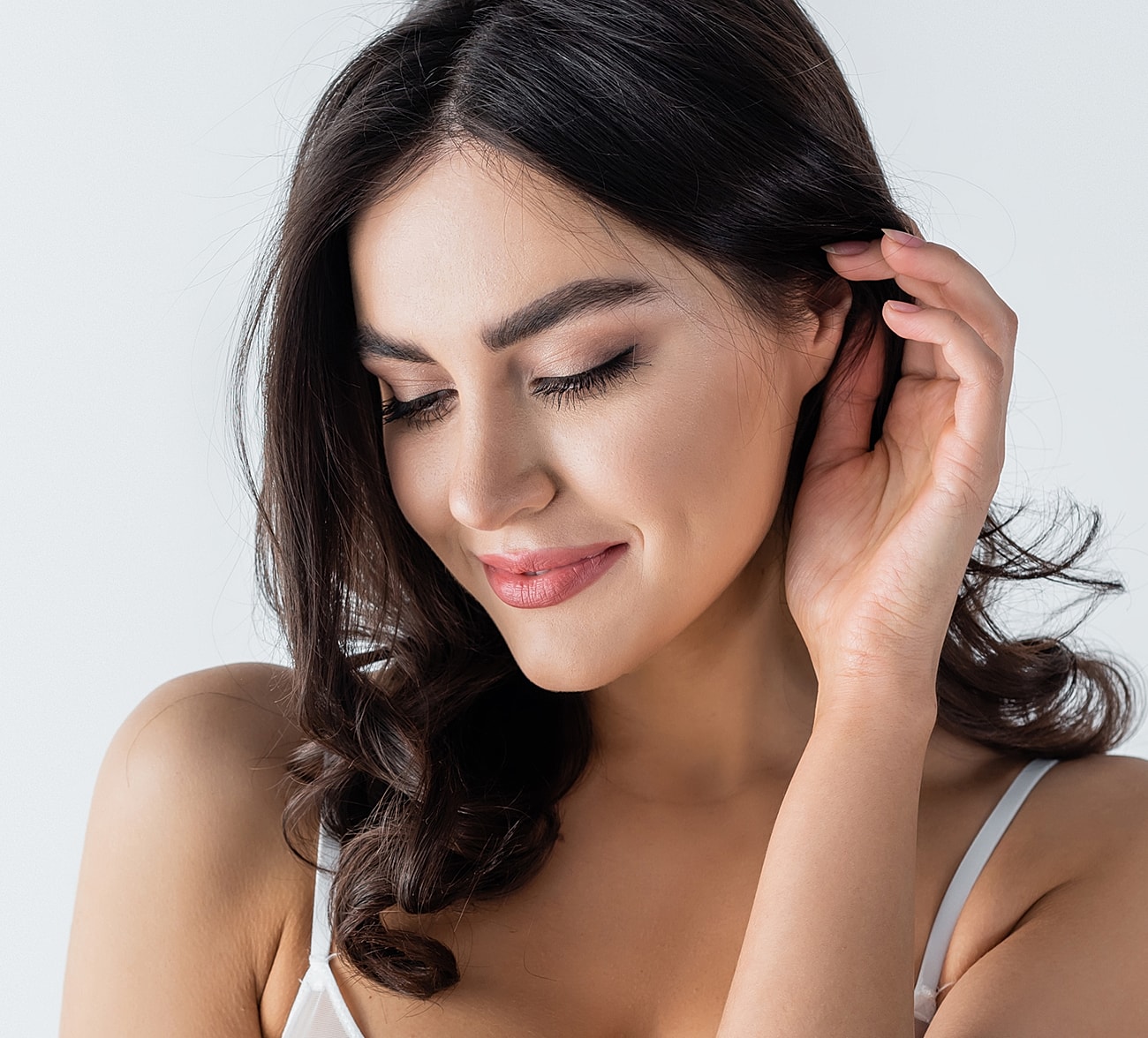 Woman with long hair smiling softly.