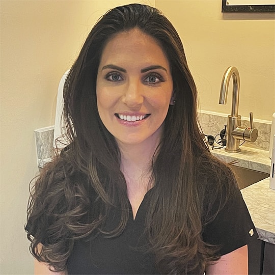 Woman smiling in a professional setting.