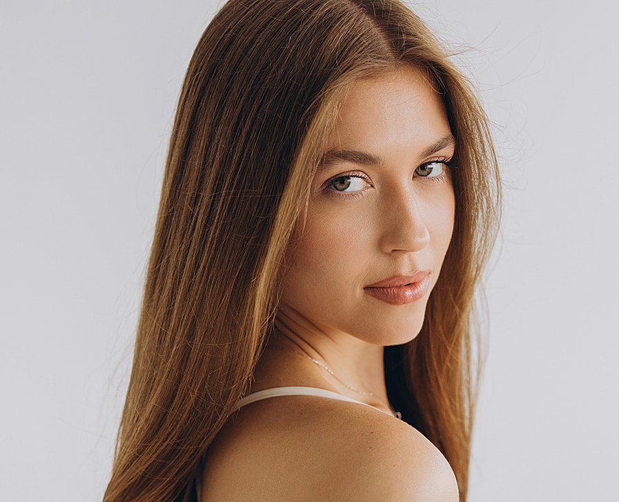 Young woman with long hair and thoughtful expression