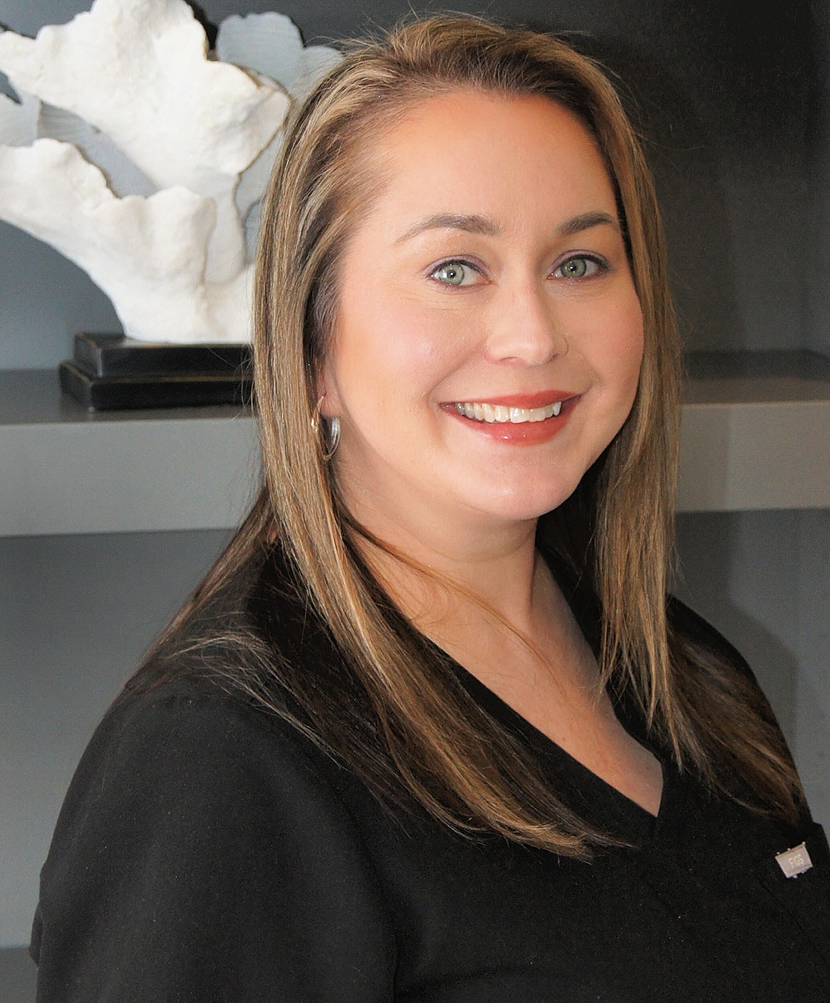 Smiling professional woman in a salon setting.