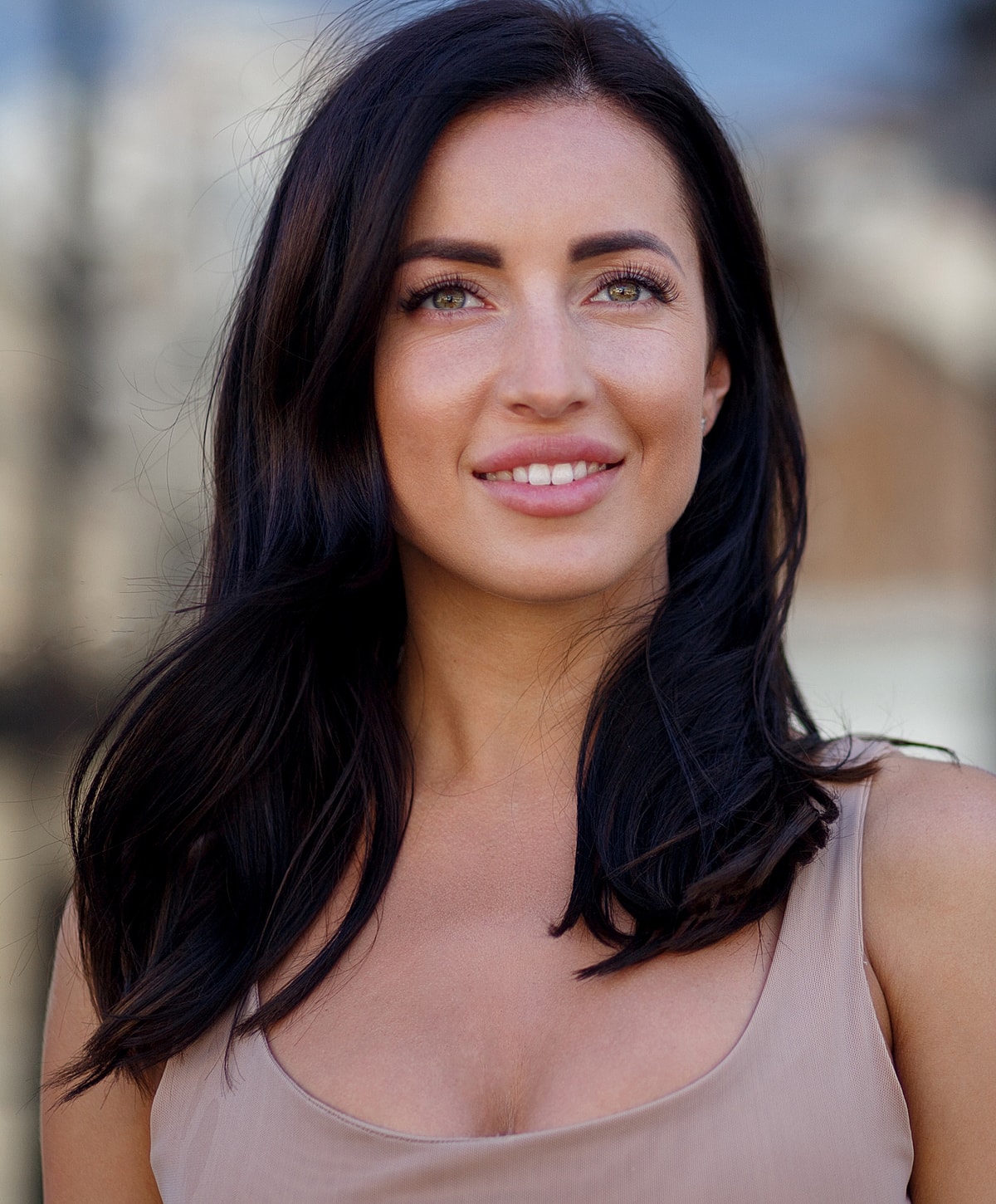 Smiling woman with long dark hair outdoors