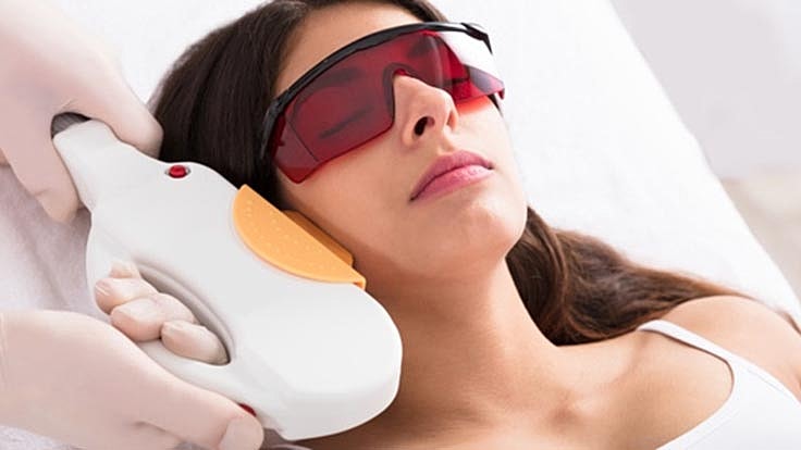 Laser treatment session for facial skin rejuvenation.