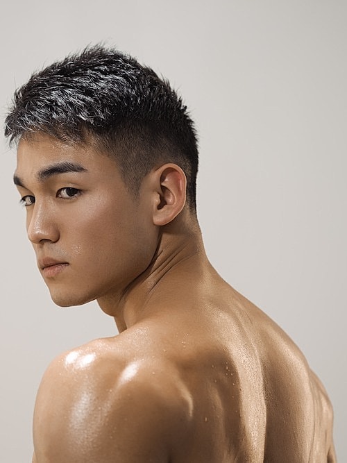 Young man with short hair, focused expression.