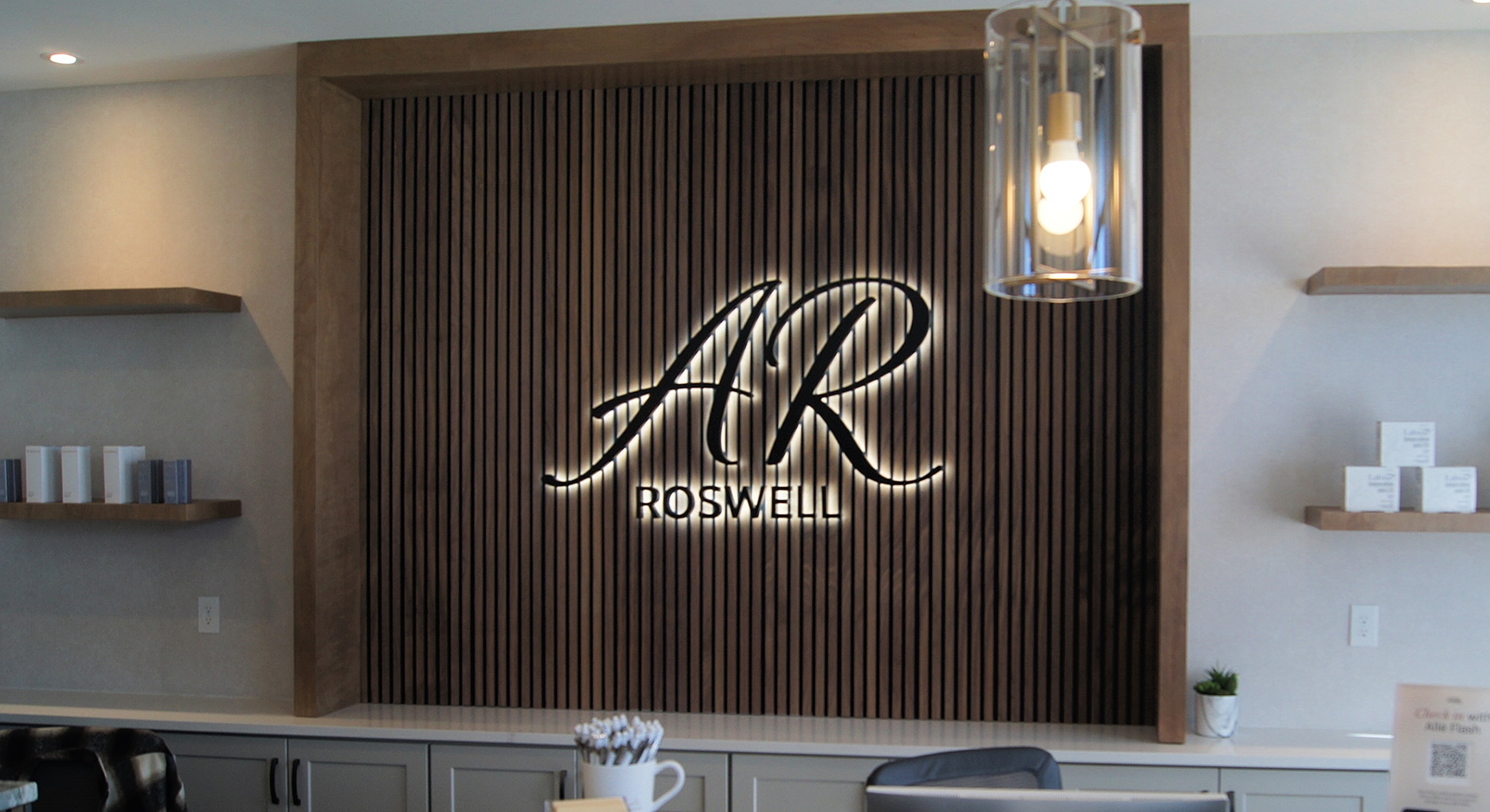 Modern reception area with illuminated logo.