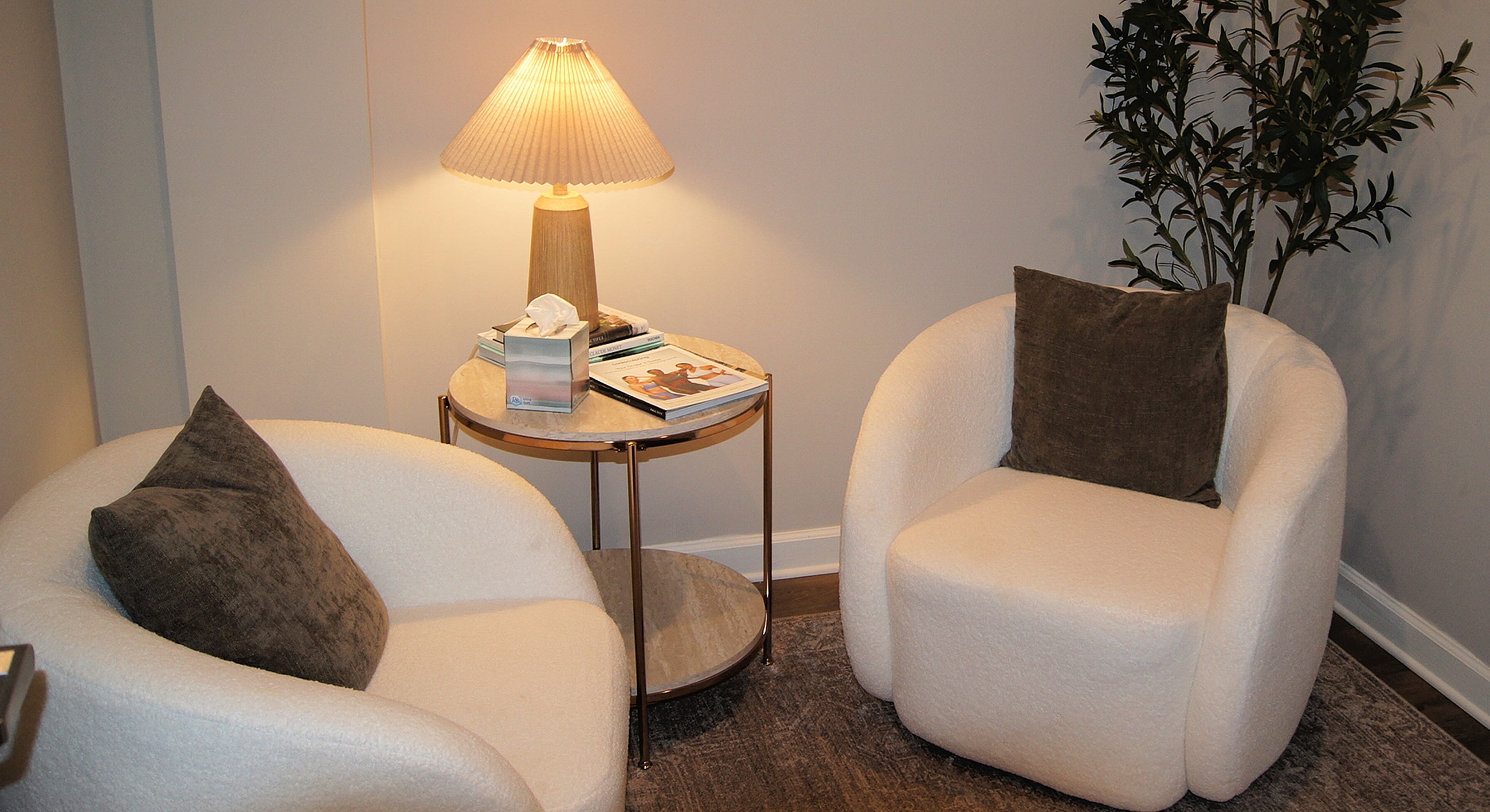 Cozy seating area with lamp and plant.