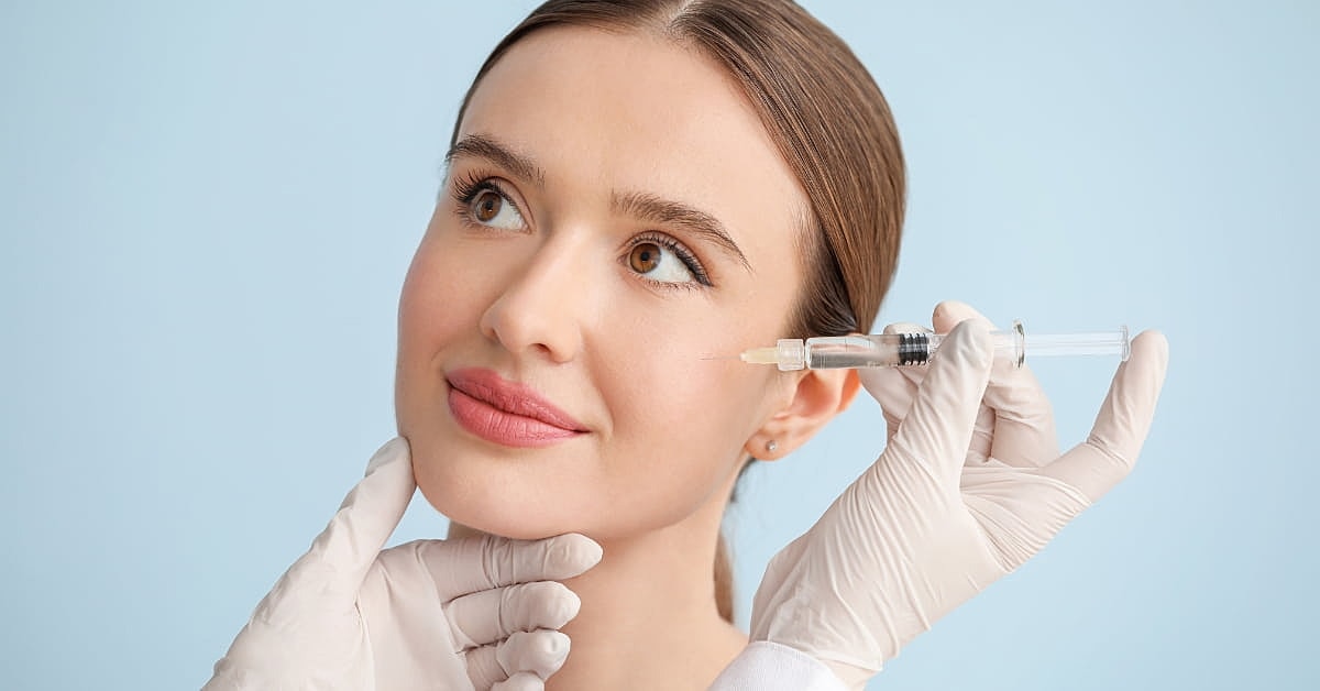 Woman receiving facial treatment with syringe.
