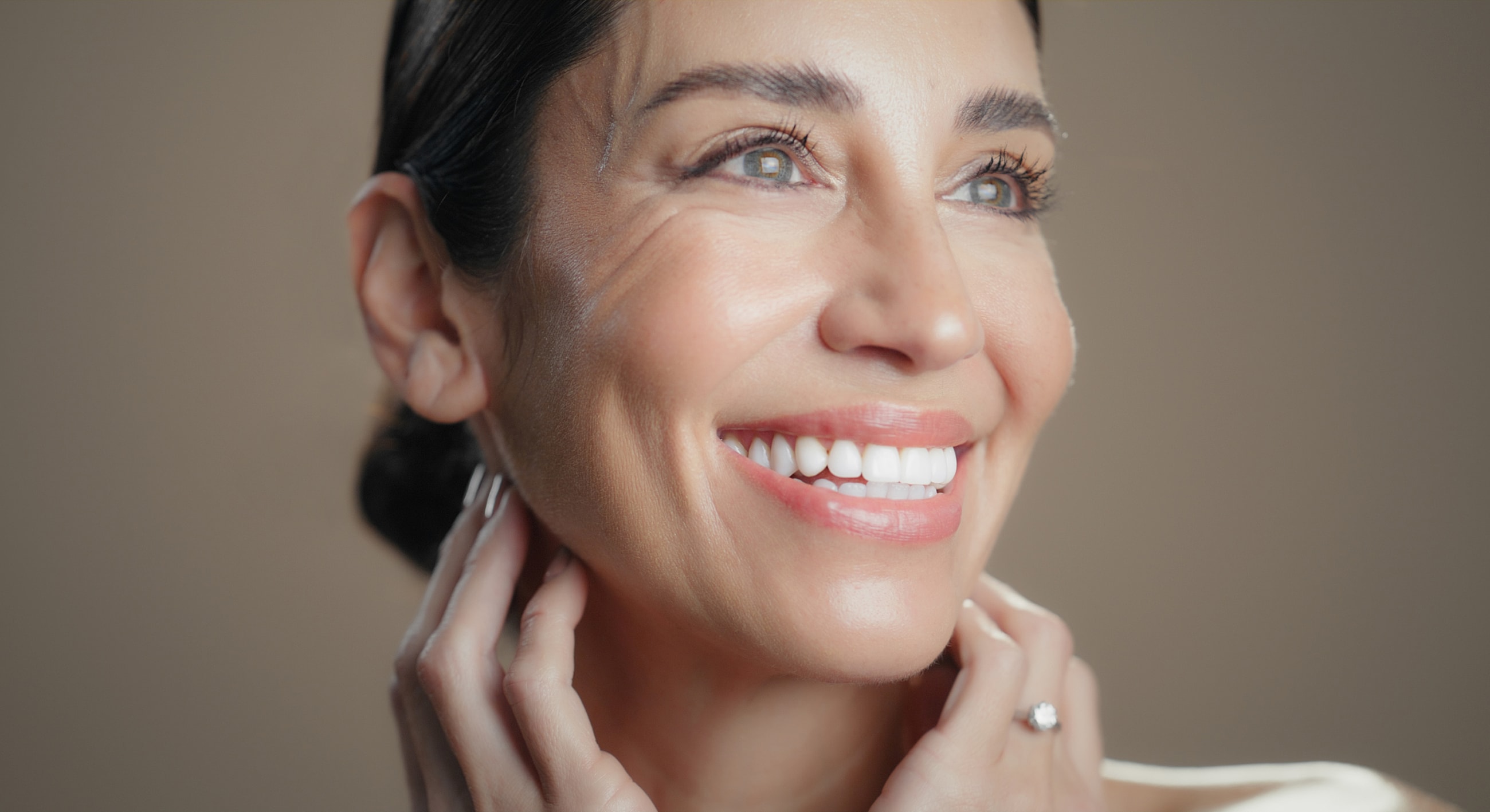 Smiling woman with glowing skin and healthy teeth