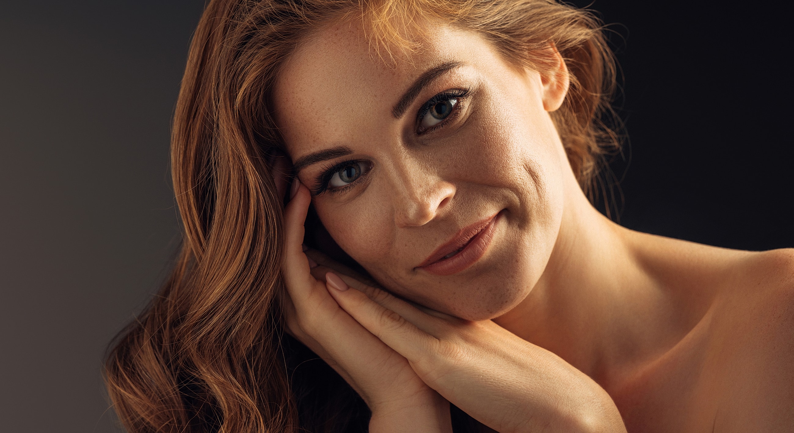 Portrait of a woman with long, wavy hair.