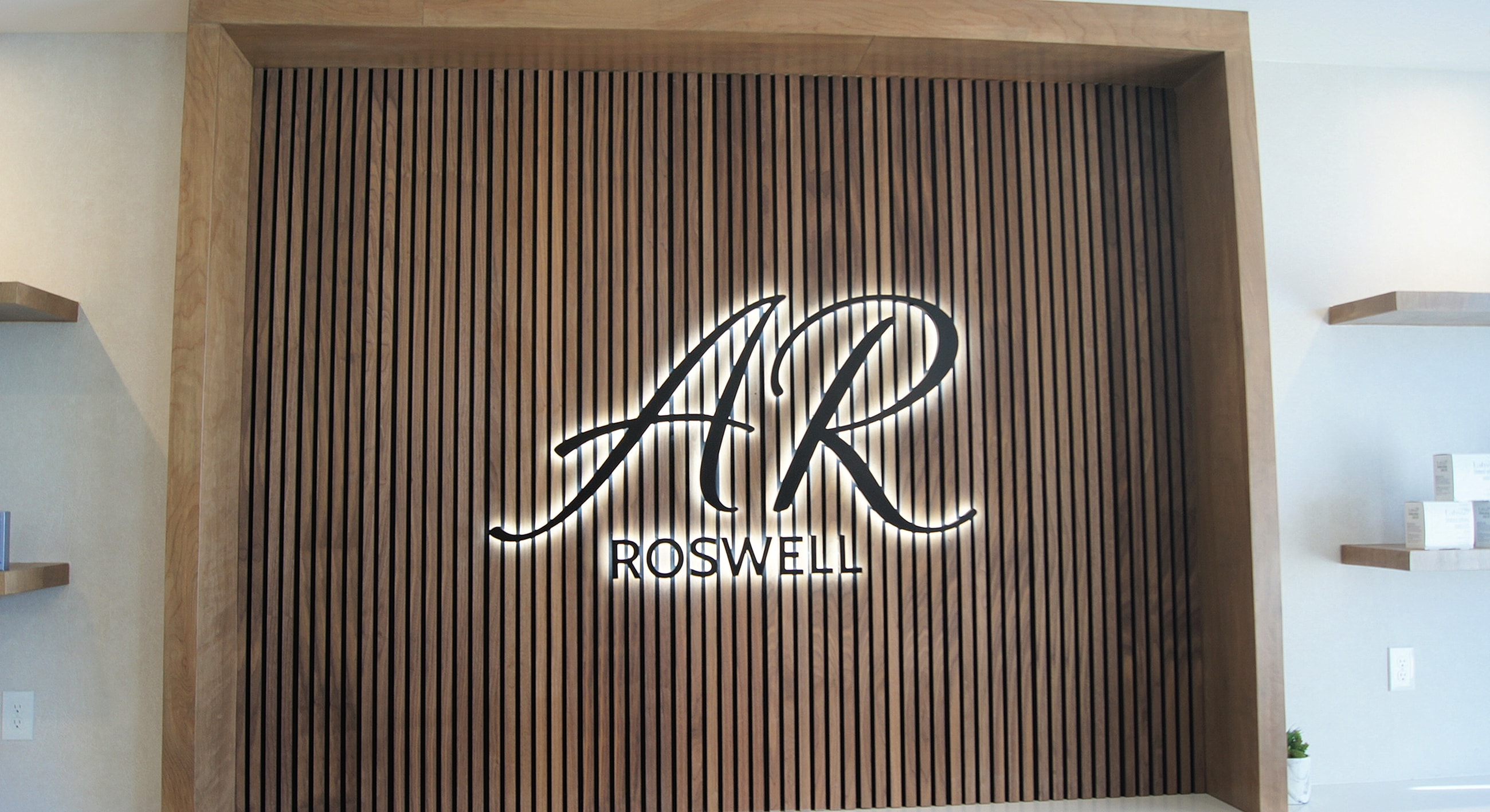 Stylish business logo on wooden wall.