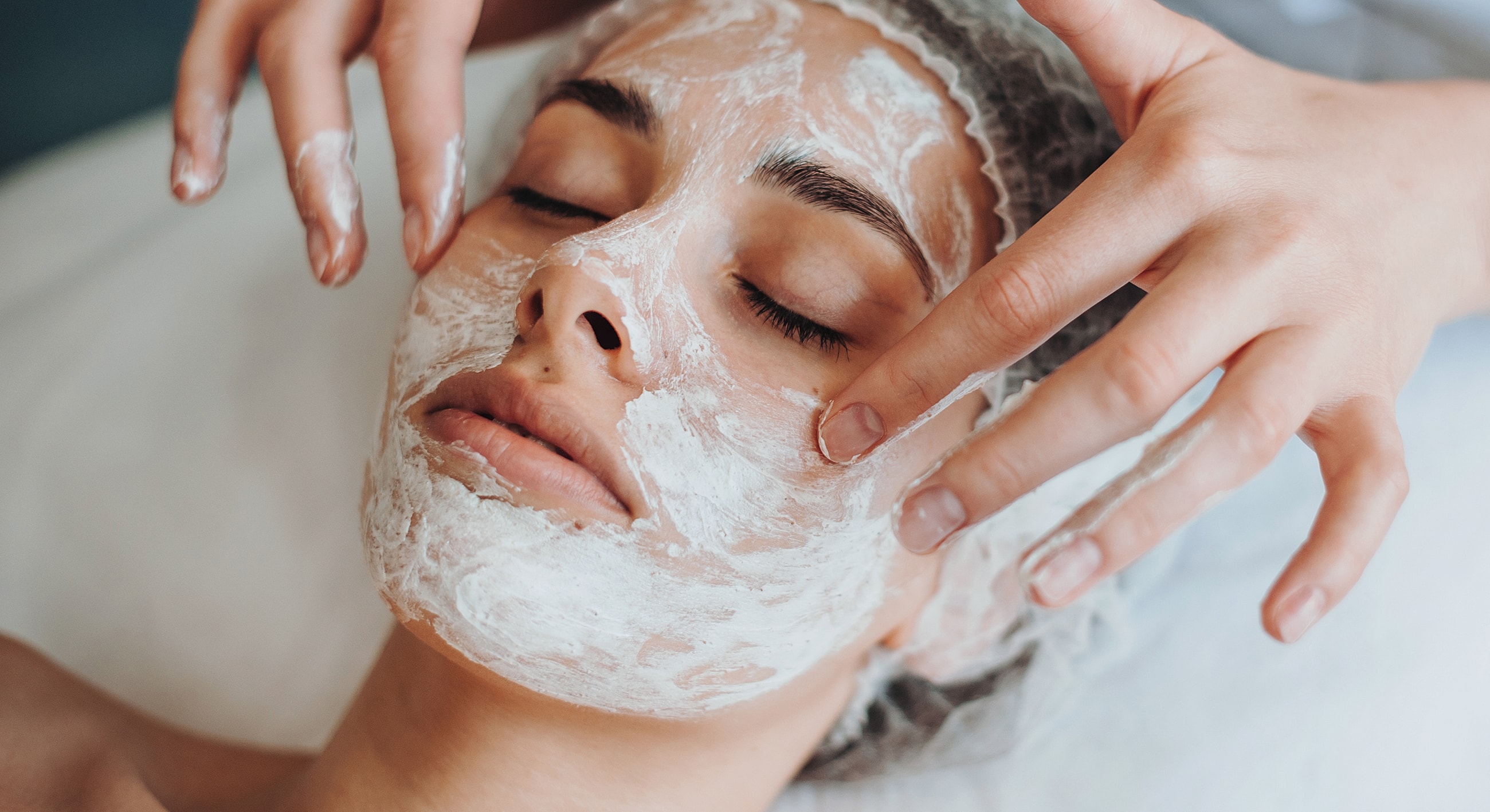 Woman receiving facial treatment in a spa.