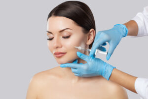 A woman receiving a dermal filler treatment from a professional, showcasing the expertise involved in achieving youthful results and explaining factors influencing dermal fillers cost.