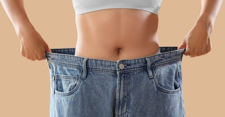 Woman wearing baggy pants, signifying weight loss